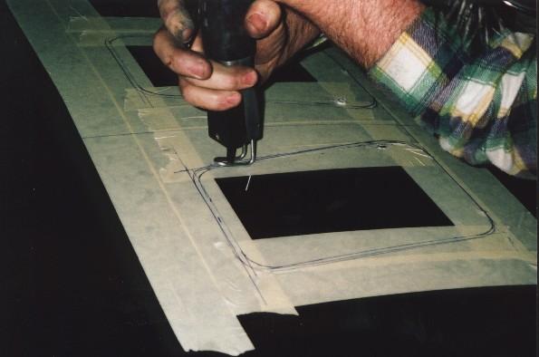 Cutting the holes for the bonnet vents with a compressed air saw